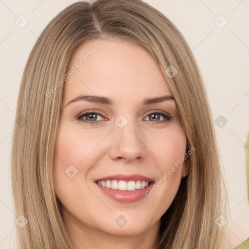 Joyful white young-adult female with long  brown hair and brown eyes