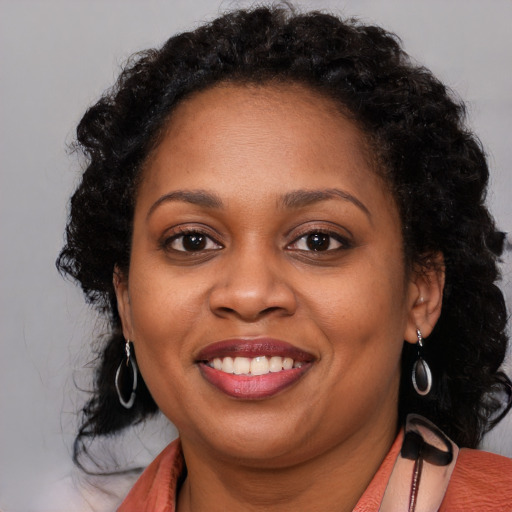 Joyful latino adult female with long  brown hair and brown eyes
