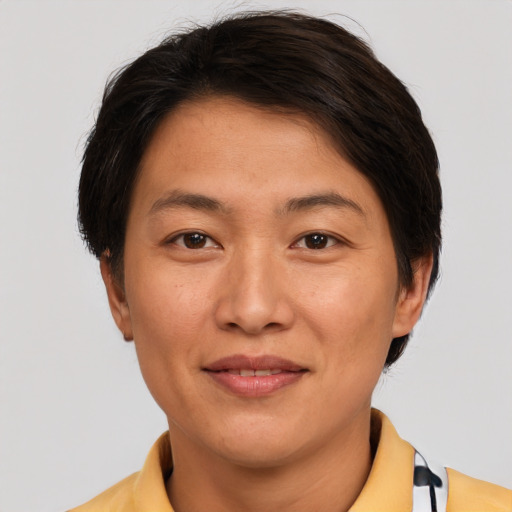 Joyful asian young-adult female with short  brown hair and brown eyes