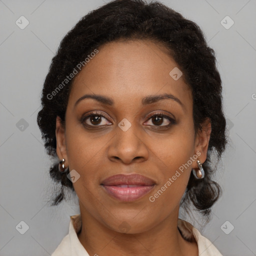 Joyful black adult female with medium  brown hair and brown eyes