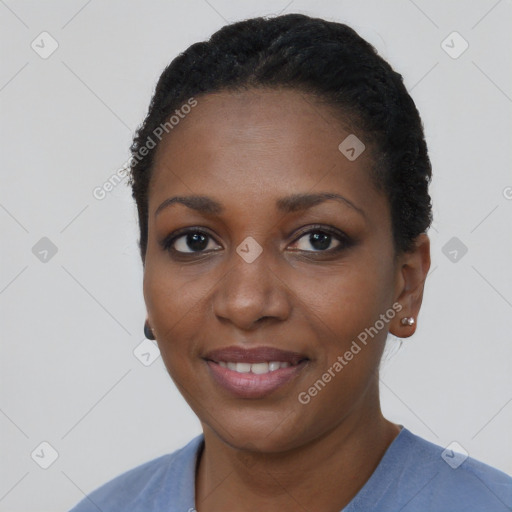 Joyful black young-adult female with short  black hair and brown eyes