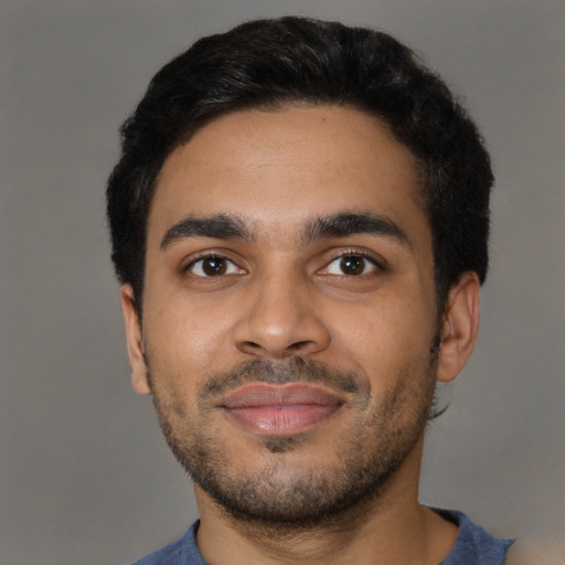 Joyful black young-adult male with short  black hair and brown eyes