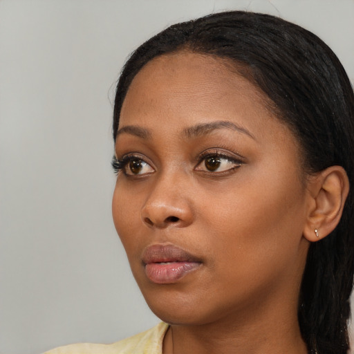 Neutral black young-adult female with long  black hair and brown eyes