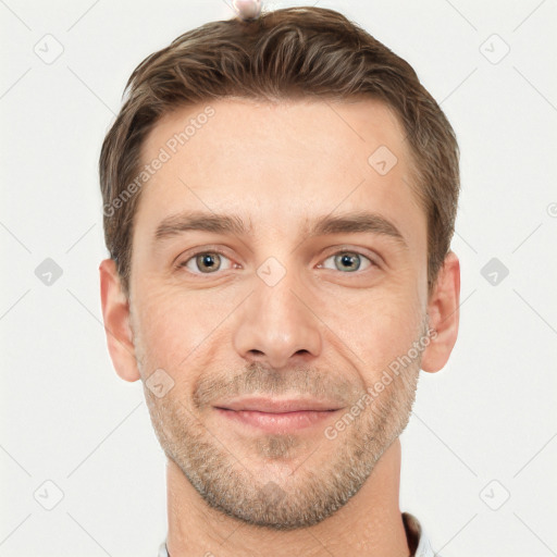 Joyful white young-adult male with short  brown hair and grey eyes