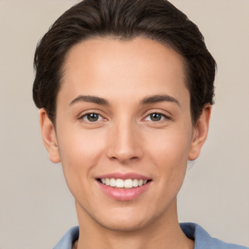 Joyful white young-adult female with short  brown hair and brown eyes