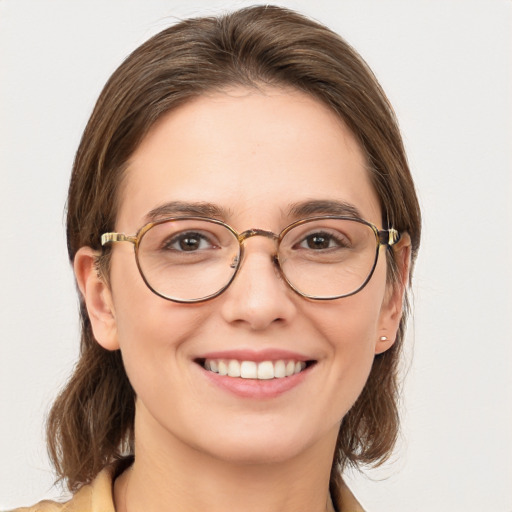 Joyful white young-adult female with medium  brown hair and green eyes