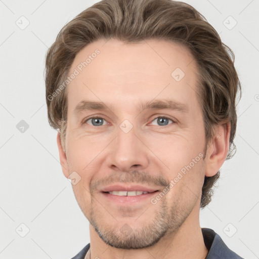 Joyful white adult male with short  brown hair and grey eyes