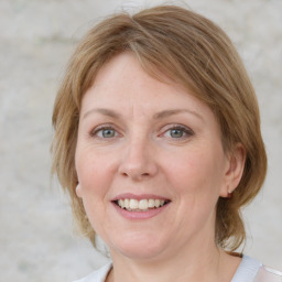 Joyful white adult female with medium  brown hair and blue eyes