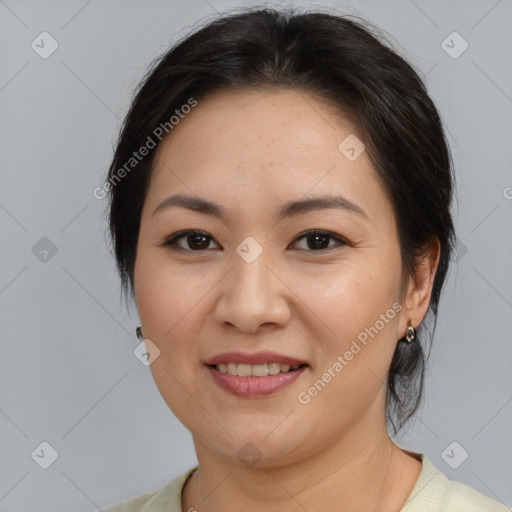 Joyful asian adult female with medium  brown hair and brown eyes