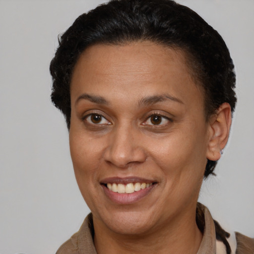 Joyful latino adult female with short  brown hair and brown eyes