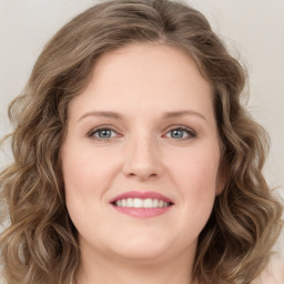 Joyful white young-adult female with long  brown hair and green eyes