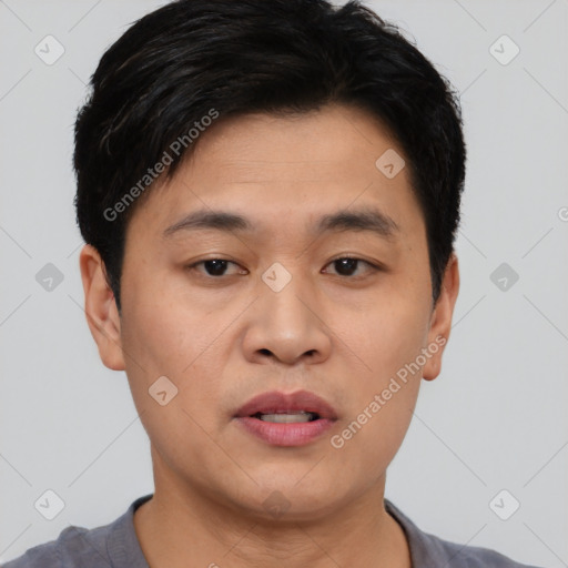 Joyful asian young-adult male with short  black hair and brown eyes
