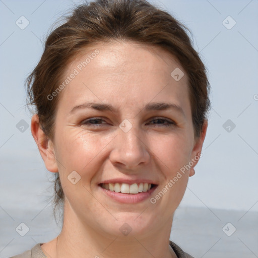 Joyful white adult female with short  brown hair and grey eyes