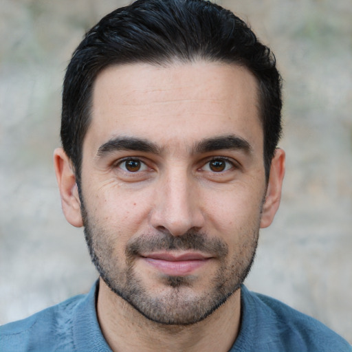 Joyful white young-adult male with short  black hair and brown eyes