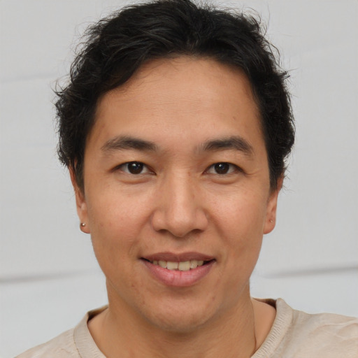 Joyful latino adult male with short  brown hair and brown eyes