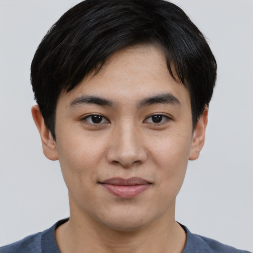 Joyful asian young-adult male with short  black hair and brown eyes