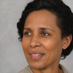 Joyful black adult female with short  brown hair and brown eyes