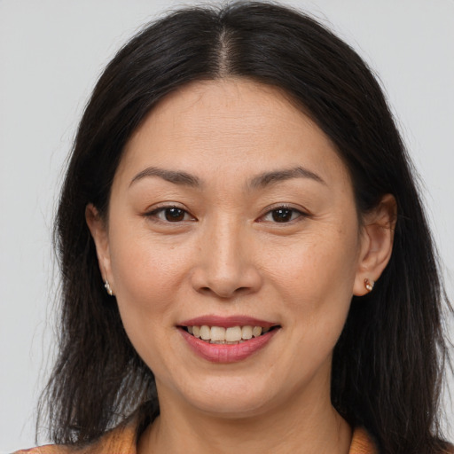 Joyful asian adult female with long  brown hair and brown eyes