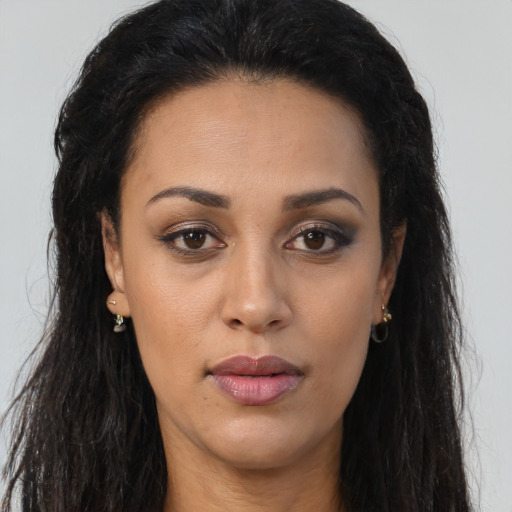 Joyful latino young-adult female with long  brown hair and brown eyes