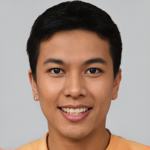 Joyful asian young-adult male with short  black hair and brown eyes