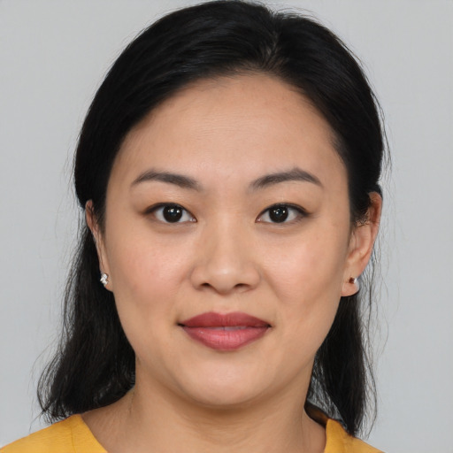 Joyful asian young-adult female with medium  black hair and brown eyes