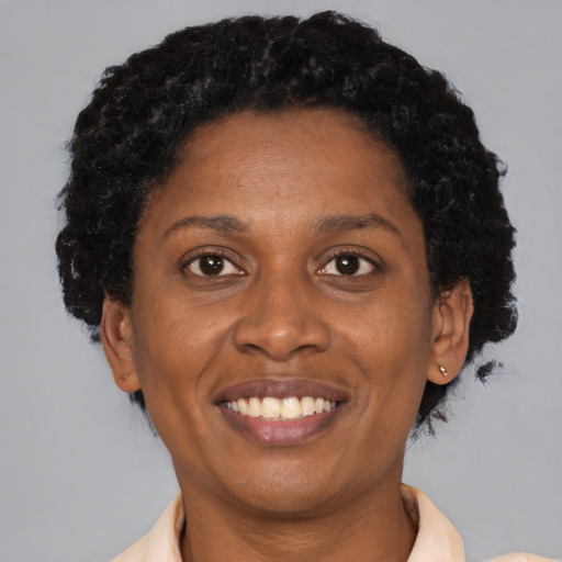 Joyful black adult female with short  brown hair and brown eyes