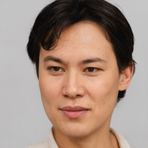 Joyful asian adult female with short  brown hair and brown eyes