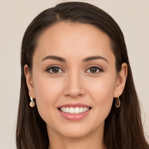 Joyful white young-adult female with long  brown hair and brown eyes