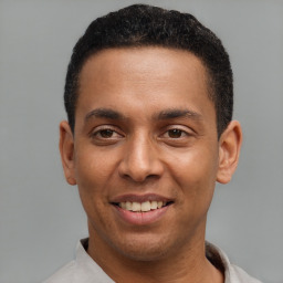 Joyful latino young-adult male with short  black hair and brown eyes