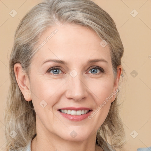 Joyful white adult female with medium  brown hair and grey eyes