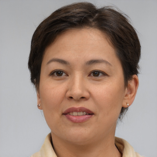 Joyful asian adult female with short  brown hair and brown eyes