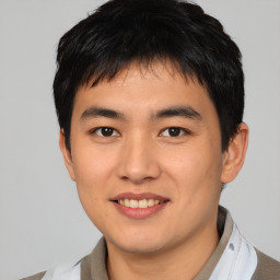 Joyful asian young-adult male with short  black hair and brown eyes