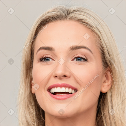 Joyful white young-adult female with long  brown hair and blue eyes