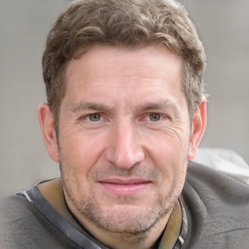 Joyful white adult male with short  brown hair and grey eyes