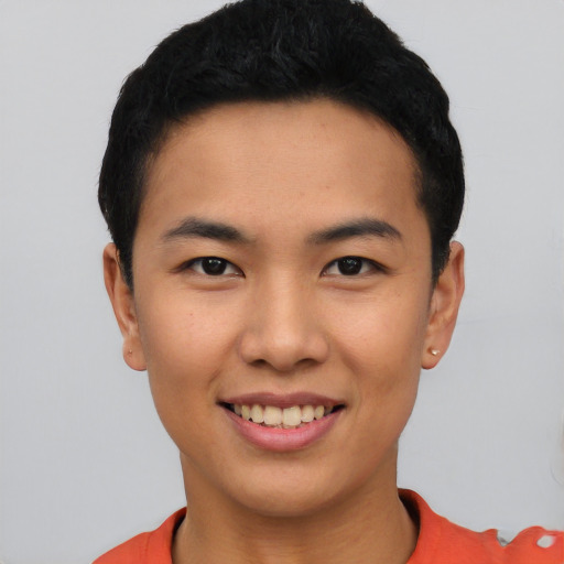 Joyful asian young-adult male with short  black hair and brown eyes