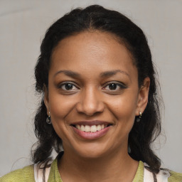 Joyful black young-adult female with medium  brown hair and brown eyes