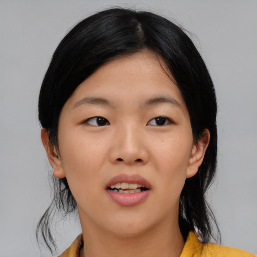 Joyful asian young-adult female with medium  black hair and brown eyes