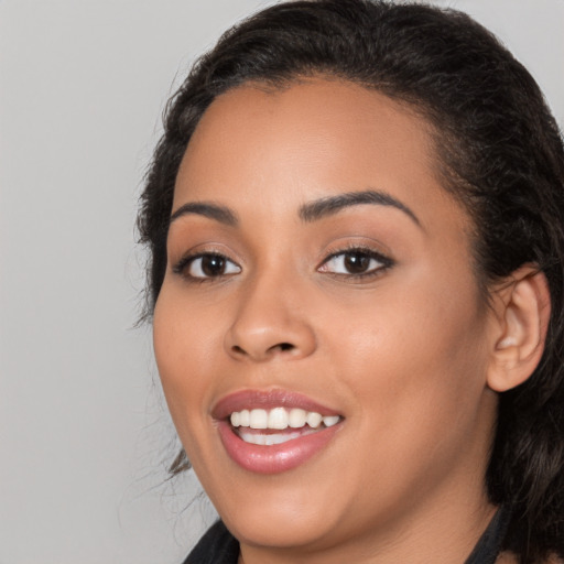 Joyful latino young-adult female with long  black hair and brown eyes