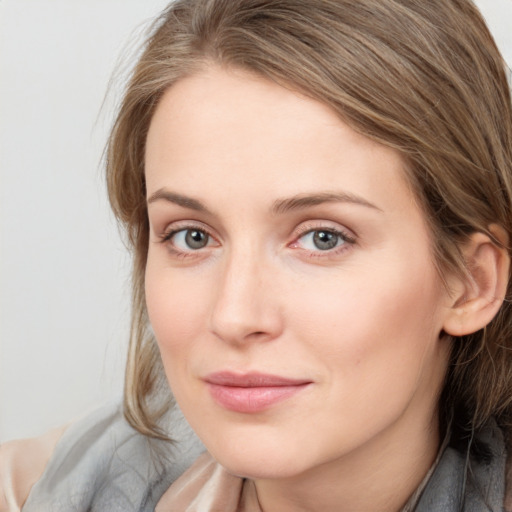 Joyful white young-adult female with medium  brown hair and blue eyes