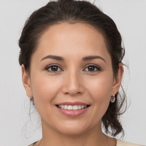 Joyful white young-adult female with medium  brown hair and brown eyes