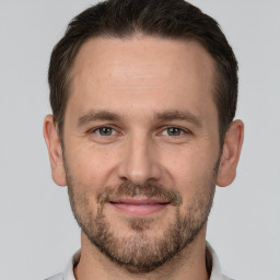 Joyful white adult male with short  brown hair and brown eyes