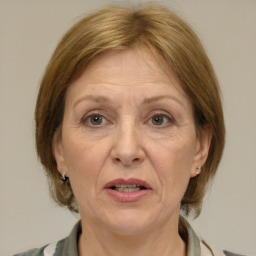 Joyful white middle-aged female with medium  brown hair and brown eyes