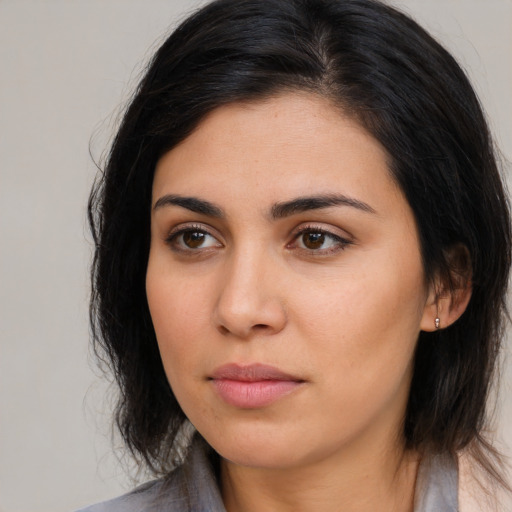 Neutral latino young-adult female with medium  brown hair and brown eyes