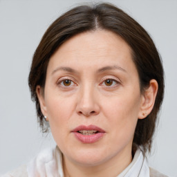 Joyful white adult female with medium  brown hair and brown eyes