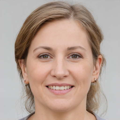 Joyful white young-adult female with medium  brown hair and grey eyes