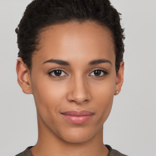 Joyful latino young-adult female with short  brown hair and brown eyes