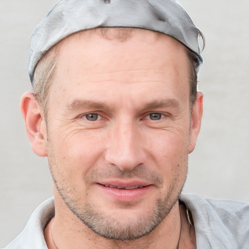 Joyful white adult male with short  brown hair and blue eyes