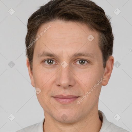 Joyful white adult male with short  brown hair and grey eyes