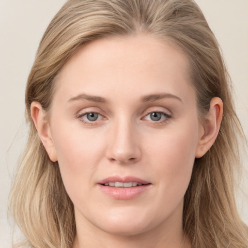 Joyful white young-adult female with long  brown hair and blue eyes