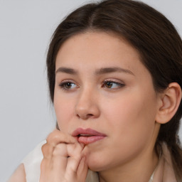 Neutral white young-adult female with medium  brown hair and brown eyes